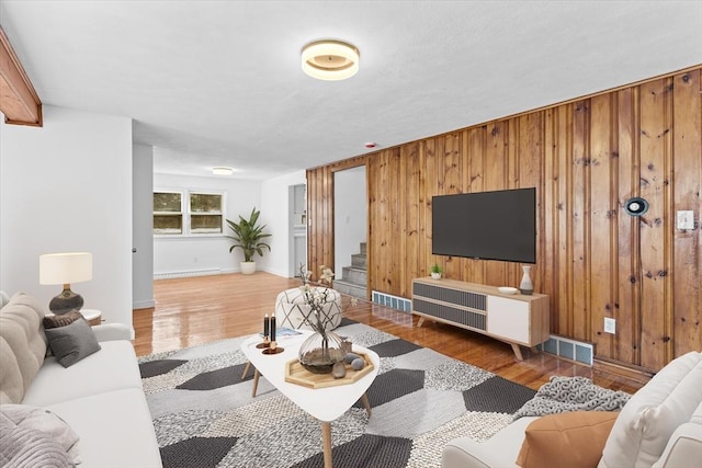 260 Great Rd, Stow, MA 01775 - living area featuring wood walls, stairs, visible vents, and wood finished floors