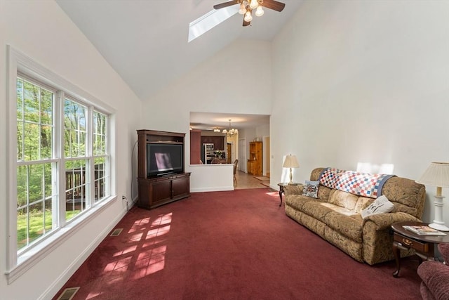living room with high vaulted ceiling, baseboards, a ceiling fan, a chandelier, and carpet