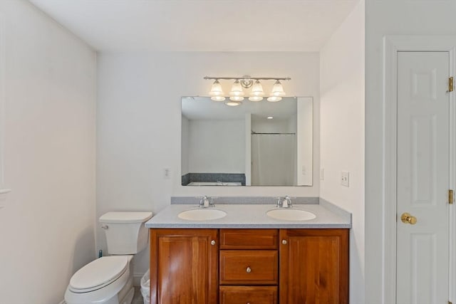 bathroom featuring toilet and double vanity