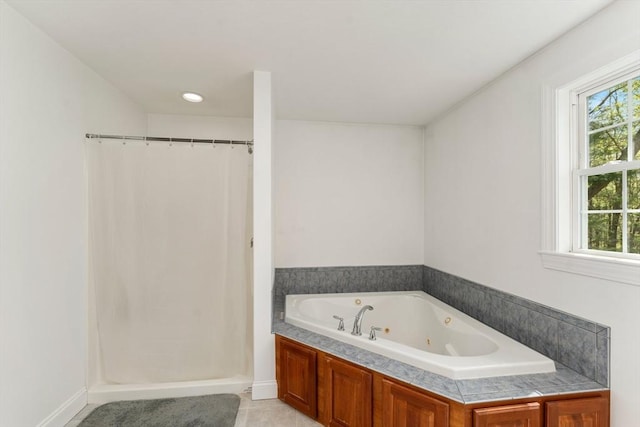 full bathroom featuring a shower with shower curtain, a jetted tub, baseboards, and tile patterned flooring