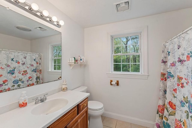 bathroom with tile patterned floors, toilet, vanity, baseboards, and curtained shower