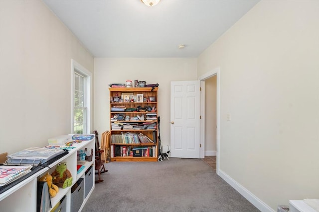 recreation room with carpet flooring and baseboards