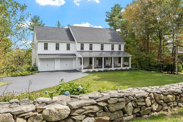 124 Osgood Rd, Charlton, MA 01507 - view of front of home featuring a porch, a front yard, a garage, asphalt driveway, and metal roof