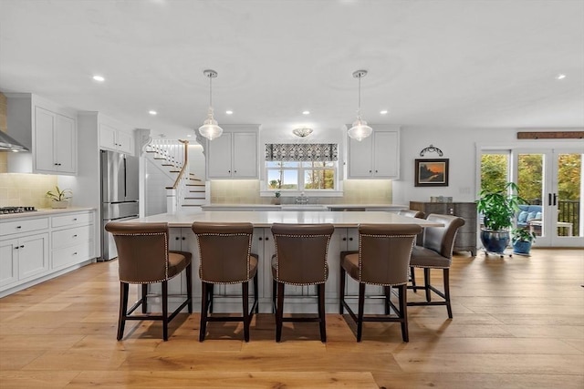 124 Osgood Rd, Charlton, MA 01507 - kitchen featuring freestanding refrigerator, light countertops, a center island, decorative backsplash, and plenty of natural light
