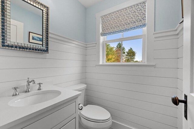 124 Osgood Rd, Charlton, MA 01507 - bathroom with toilet, vanity, and wooden walls