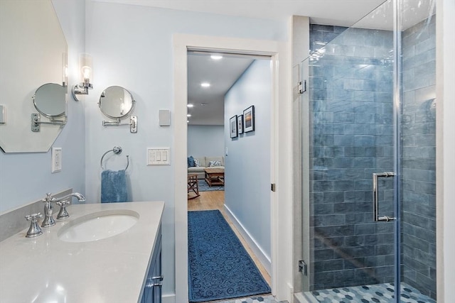 124 Osgood Rd, Charlton, MA 01507 - ensuite bathroom featuring a shower stall, vanity, wood finished floors, and baseboards