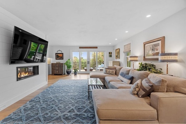 124 Osgood Rd, Charlton, MA 01507 - living room featuring french doors, a large fireplace, light wood-style floors, and recessed lighting