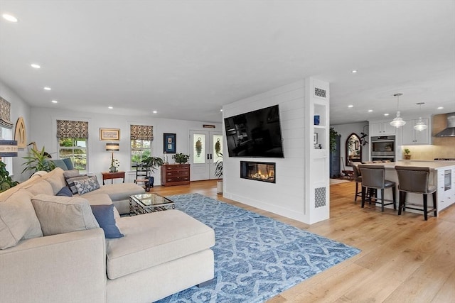 124 Osgood Rd, Charlton, MA 01507 - living room with recessed lighting, light wood-style floors, and a fireplace
