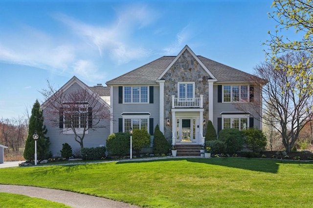 58 Bridle Path, Tewksbury, MA 01876 - view of front of property featuring stone siding, a front lawn, and a balcony