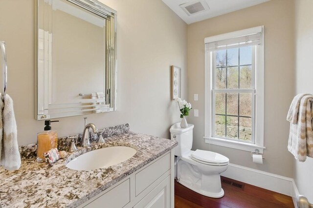 58 Bridle Path, Tewksbury, MA 01876 - bathroom with toilet, visible vents, wood finished floors, and vanity