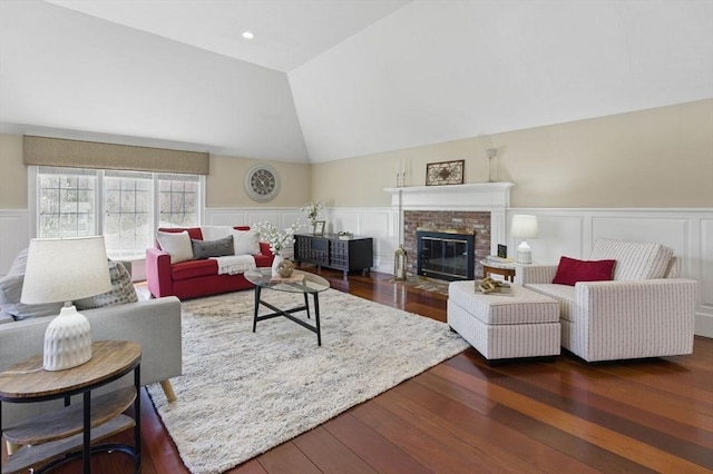 58 Bridle Path, Tewksbury, MA 01876 - living room with a fireplace, a decorative wall, a wainscoted wall, lofted ceiling, and hardwood / wood-style flooring