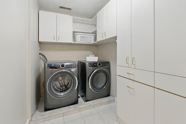 58 Bridle Path, Tewksbury, MA 01876 - laundry room featuring cabinet space, tile patterned floors, visible vents, and washer and dryer
