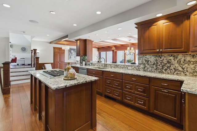 58 Bridle Path, Tewksbury, MA 01876 - kitchen featuring beam ceiling, light wood-type flooring, a center island, a sink, and stainless steel appliances