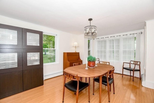 670 Front St, Marion, MA 02738 - dining room with baseboard heating, a chandelier, light wood finished floors, and ornamental molding