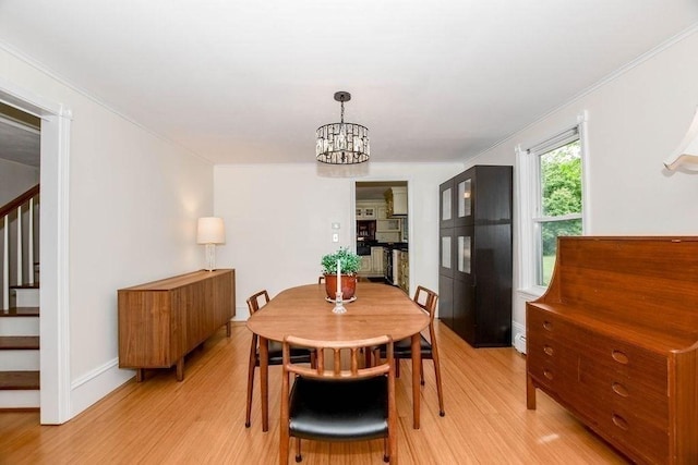 670 Front St, Marion, MA 02738 - dining area featuring stairs, light wood-style floors, ornamental molding, and a chandelier