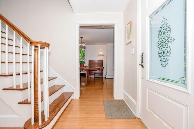 670 Front St, Marion, MA 02738 - entryway with stairway, light wood-style flooring, a chandelier, and crown molding