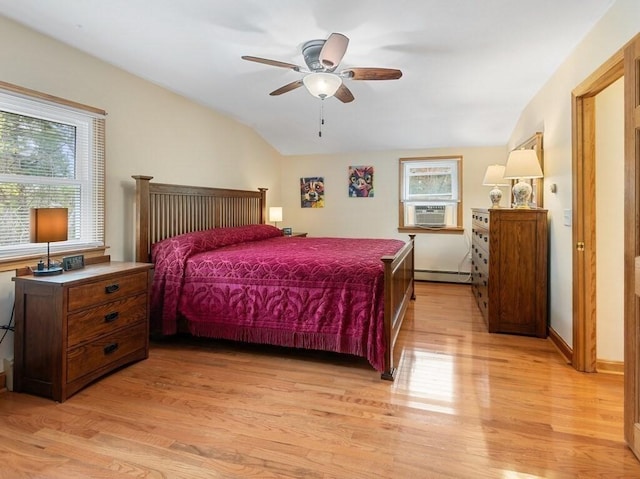 bedroom with baseboard heating, vaulted ceiling, baseboards, cooling unit, and light wood-style flooring