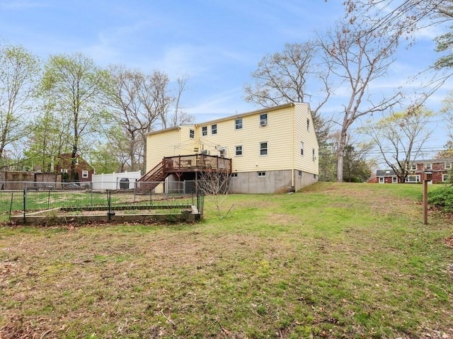 back of house with a lawn, a deck, stairway, and fence