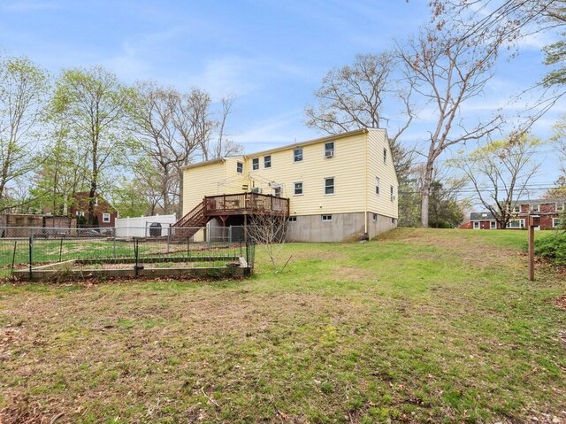 back of house with fence, a wooden deck, a yard, and stairway