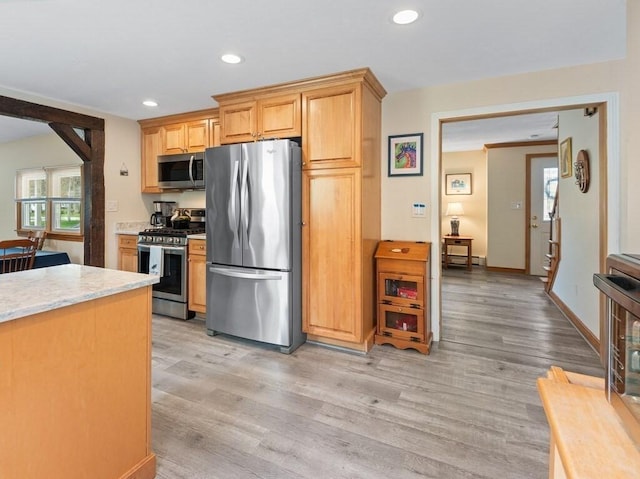 kitchen featuring appliances with stainless steel finishes, light wood-type flooring, recessed lighting, and light stone counters