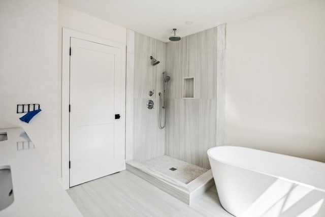 108 S St, Reading, MA 01867 - bathroom with a walk in shower, a freestanding tub, and wood finished floors