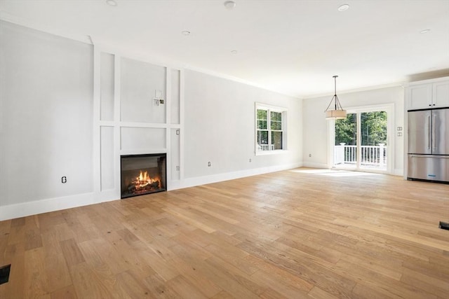 108 S St, Reading, MA 01867 - unfurnished living room with a large fireplace, light wood finished floors, and ornamental molding