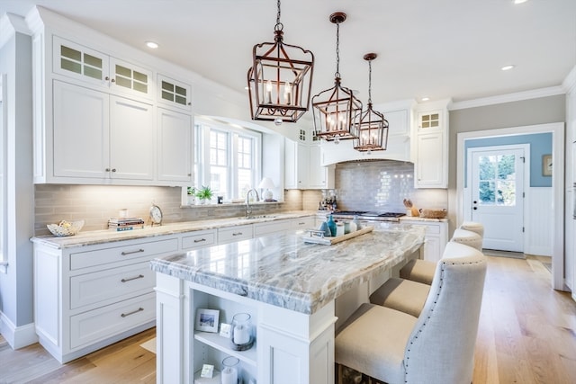 kitchen featuring a kitchen island, white cabinets, and decorative backsplash