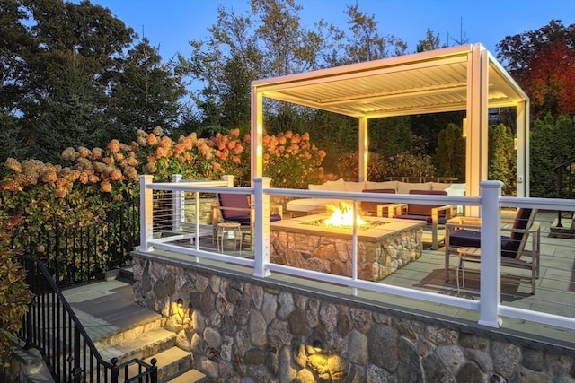 wooden terrace featuring an outdoor fire pit