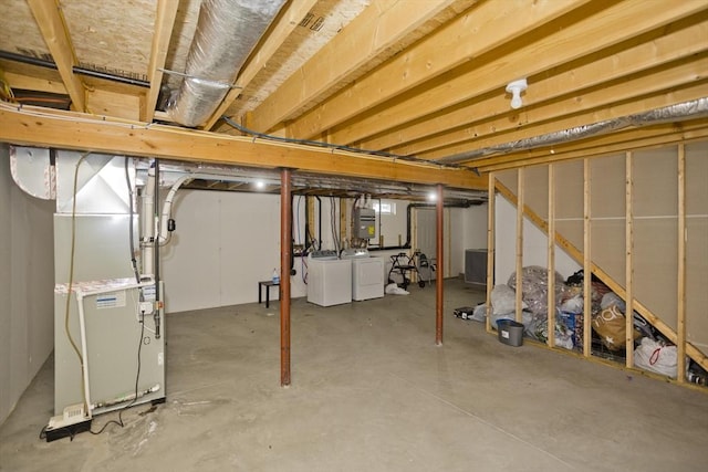 basement with separate washer and dryer and heating unit