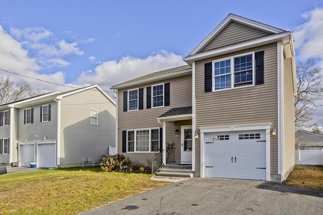 view of property featuring a garage and a front yard