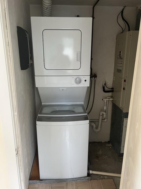 121 Longwood Ave Unit 4B, Brookline, MA 02446 - laundry room featuring stacked washer / dryer