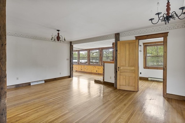 38 Lakeshore Dr, Wayland, MA 01778 - unfurnished living room with a chandelier, baseboard heating, light wood-type flooring, and baseboards