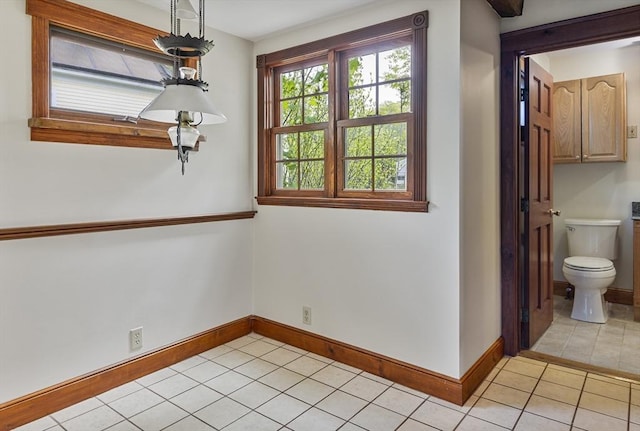 38 Lakeshore Dr, Wayland, MA 01778 - unfurnished dining area featuring light tile patterned floors and baseboards