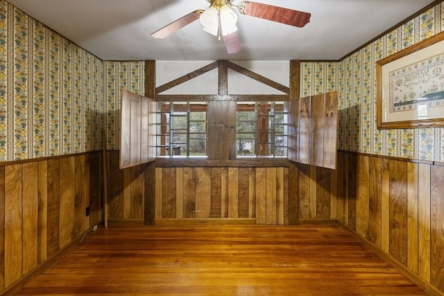 38 Lakeshore Dr, Wayland, MA 01778 - empty room with wallpapered walls, a wainscoted wall, hardwood / wood-style floors, wooden walls, and a ceiling fan