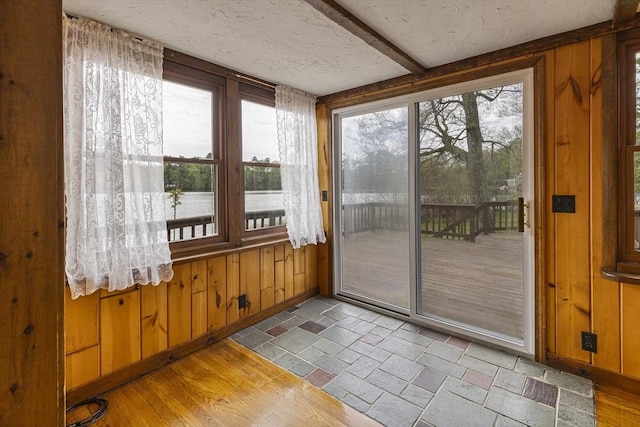 38 Lakeshore Dr, Wayland, MA 01778 - doorway with wooden walls and stone finish floors
