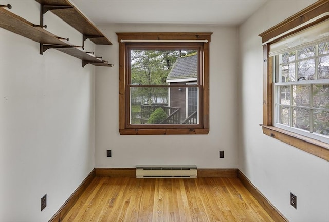 38 Lakeshore Dr, Wayland, MA 01778 - unfurnished room featuring a baseboard heating unit, light wood-style flooring, and baseboards