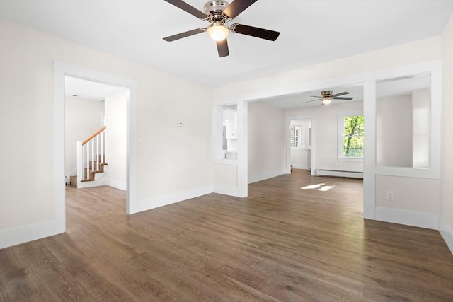 59 Altamont St, Haverhill, MA 01830 - spare room featuring baseboard heating, a ceiling fan, wood finished floors, stairway, and baseboards