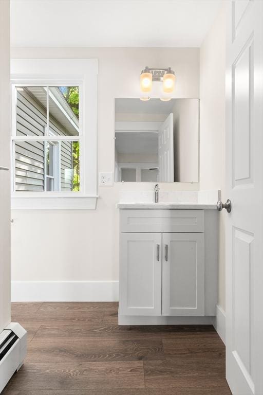 59 Altamont St, Haverhill, MA 01830 - bathroom featuring a baseboard radiator, baseboards, wood finished floors, and vanity