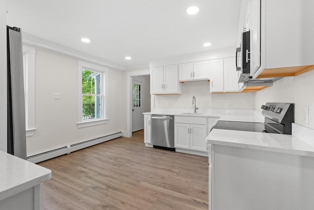 59 Altamont St, Haverhill, MA 01830 - kitchen featuring a baseboard heating unit, stainless steel appliances, a sink, white cabinetry, and recessed lighting
