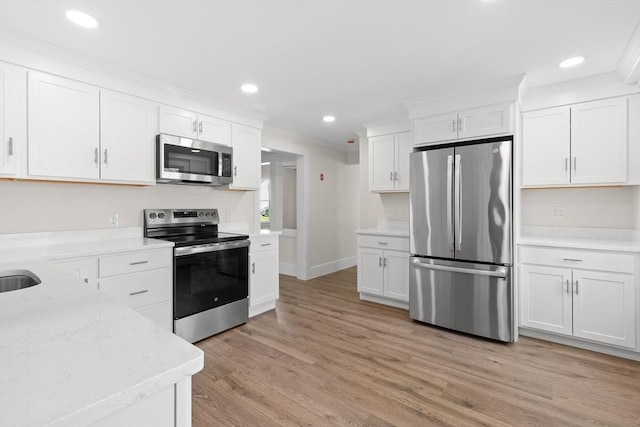 59 Altamont St, Haverhill, MA 01830 - kitchen with appliances with stainless steel finishes, white cabinetry, recessed lighting, light wood-style flooring, and crown molding