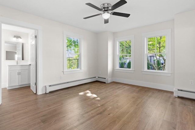 59 Altamont St, Haverhill, MA 01830 - spare room with baseboard heating, wood finished floors, baseboards, ceiling fan, and a sink