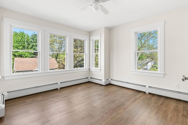 59 Altamont St, Haverhill, MA 01830 - spare room featuring healthy amount of natural light, wood finished floors, a ceiling fan, and a baseboard heating unit