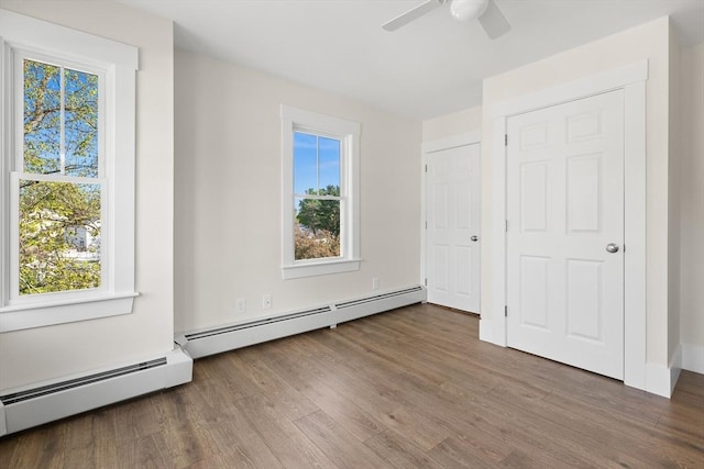 59 Altamont St, Haverhill, MA 01830 - unfurnished bedroom featuring multiple windows, wood finished floors, a baseboard heating unit, and a ceiling fan