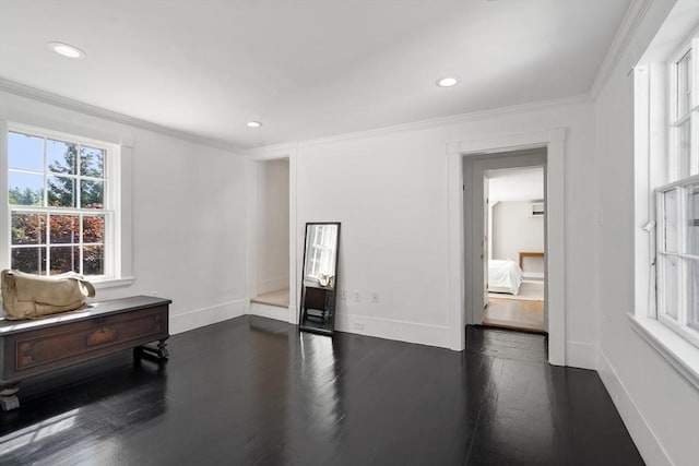 interior space with baseboards, dark wood-type flooring, and crown molding