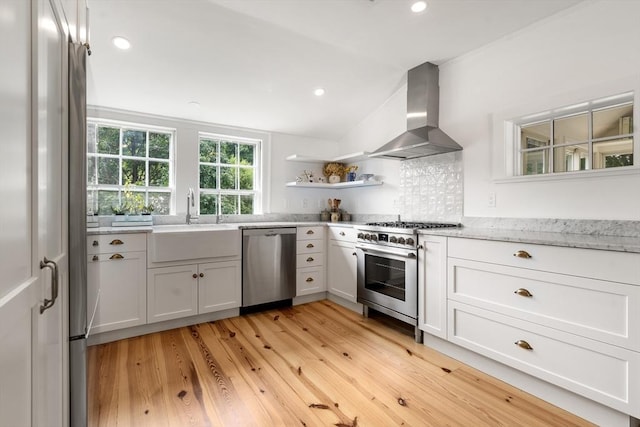 kitchen with appliances with stainless steel finishes, white cabinetry, open shelves, and exhaust hood