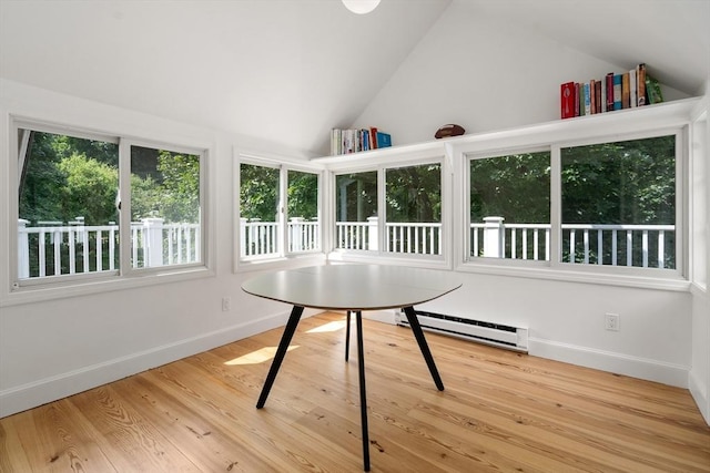 unfurnished sunroom featuring vaulted ceiling and baseboard heating