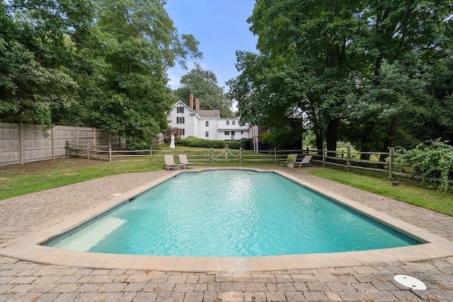 view of pool with a fenced backyard, a lawn, and a fenced in pool