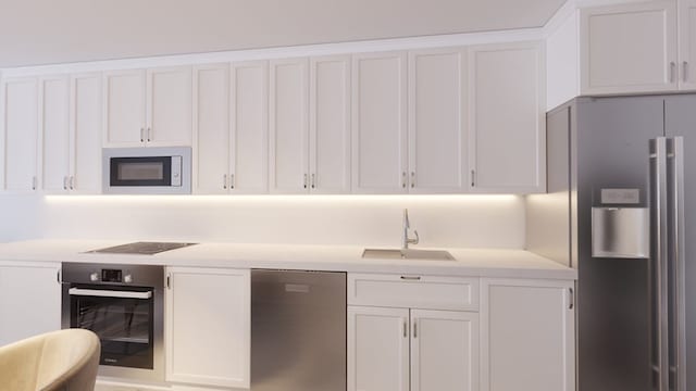 kitchen featuring appliances with stainless steel finishes, sink, and white cabinets