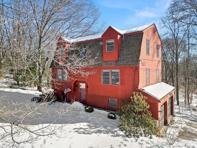 view of front of home featuring roof with shingles and a gambrel roof