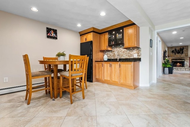 2 Cider Mill Rd, Peabody, MA 01960 - dining space with recessed lighting, bar with sink, baseboard heating, a stone fireplace, and baseboards